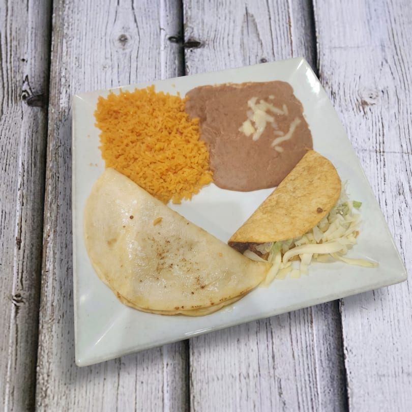 A white plate holds a Mexican meal with rice, refried beans, a quesadilla, and a taco.